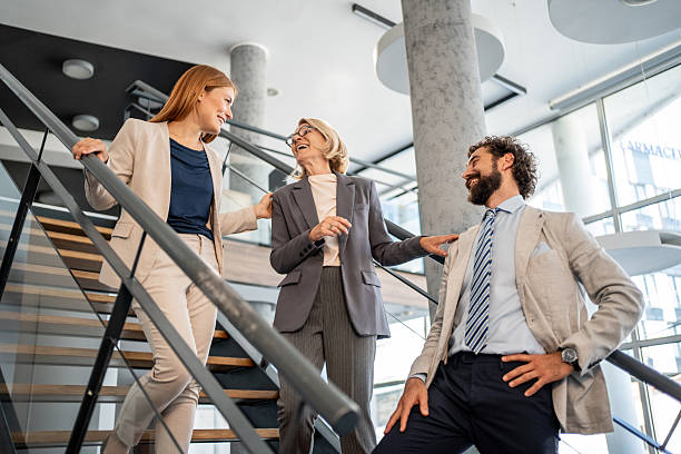 istock Businesspeople walking and talking on stairs in modern office 2225034418