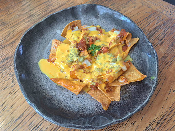 Supreme Nachos N Cheese With Corn Tortilla Chips, Ground Beef Tomato Sauce, Mozzarella, Guacamole Cheddar Cheese And Tomato Salsa. Appetizer Food Menu.