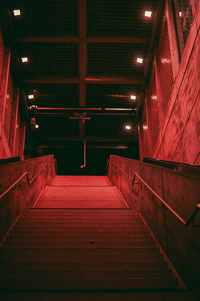 istock A dimly lit staircase at Leipzig Wilhelm Leuschner Platz station emphasizes the station's minimalist, industrial aesthetic. The geometric lighting and metallic details create a stark, modern atmosphere. 2225035033