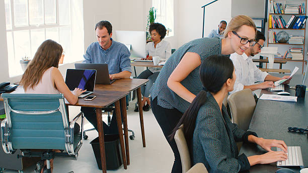 istock Multi-Cultural Business Team Working At Desks On Computers In Modern Open Plan Office 2225037030