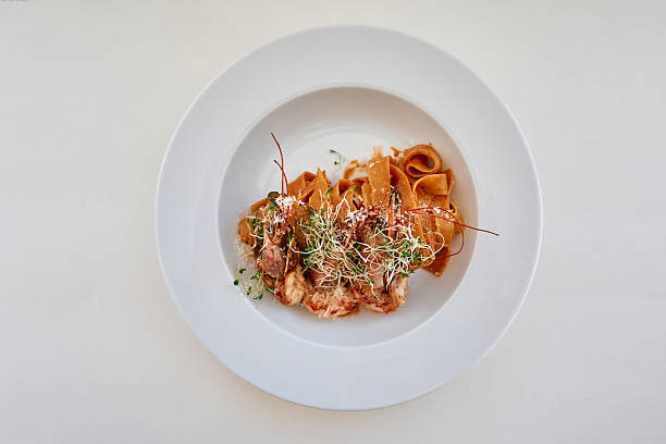 istock Gourmet pasta dish with microgreens and tomato sauce on white plate 2225037095