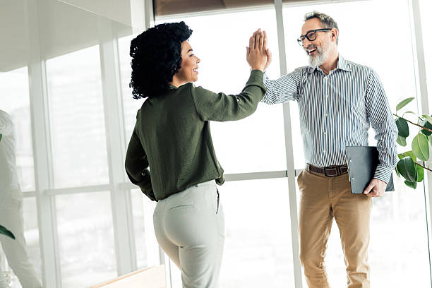 istock Professional colleagues celebrate successful collaboration with a high five in modern office space, promoting teamwork and partnership 2225037745