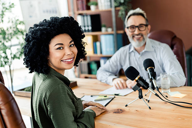 istock Professional podcast recording session with diverse team working collaboratively in a modern office environment 2225037771