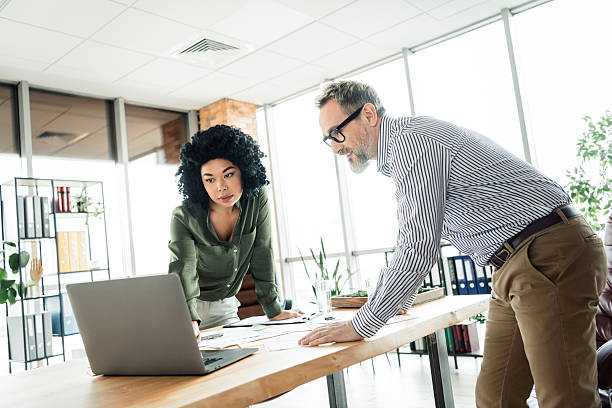 istock Professional coworkers collaborating in a modern office setting, working together on project planning and professional tasks 2225037793