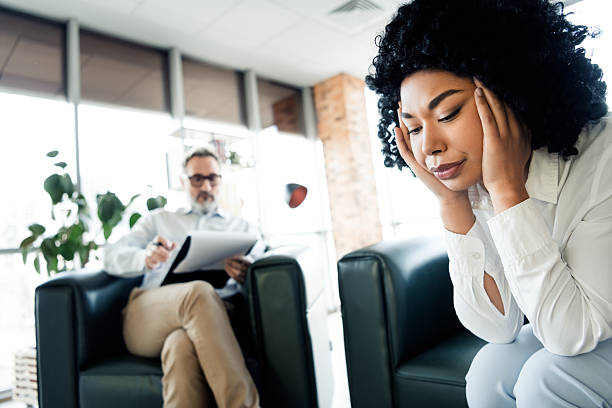 istock Professional woman in thoughtful discussion with a consultant in a bright office setting, showcasing teamwork and collaboration 2225037864