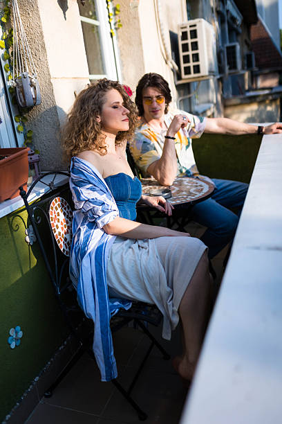 istock Couple Enjoying Quiet Talk on Apartment Balcony 2225041573