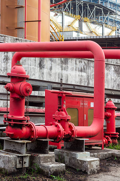 istock Industrial Fire Safety System: Red Hydrant and Piping at a Manufacturing Facility 2225041744