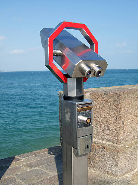 01 AUG 2022 - St. Malo - France - A viewing binoculars on the sea front overlooking the sea and beach in a seaside destination