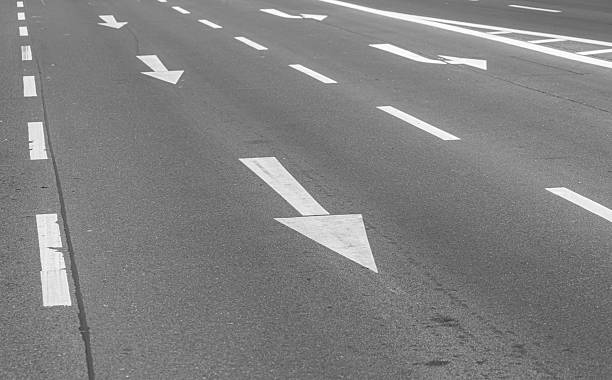 istock Directional arrows and road markings on a road 2225047380