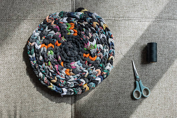 Recycled round fabric rug with sewing tools