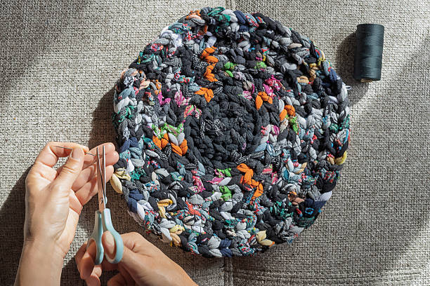 istock Final stitching of round recycled fabric rug 2225049095