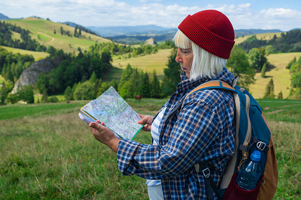 istock Female Hiker Navigating with a Map in the Mountains 2225050828