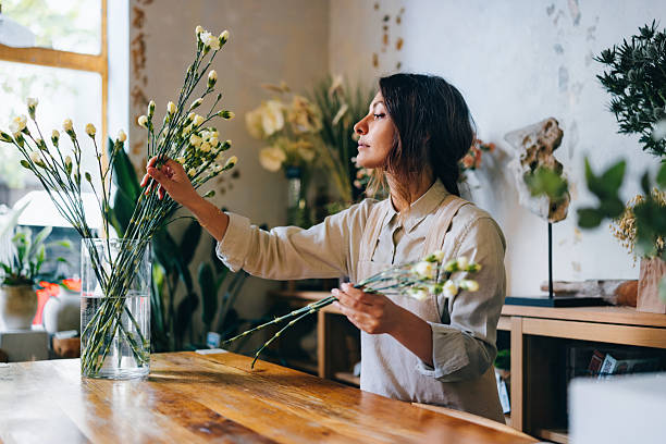 istock Florist Arranging Fresh Flowers in a Stylish and Bright Workshop 2225050984