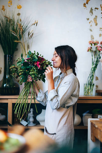 Florist Smelling Fresh Bouquet in a Charming Workshop Setting