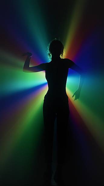 istock Silhouette of woman in rainbow light burst 2225051173