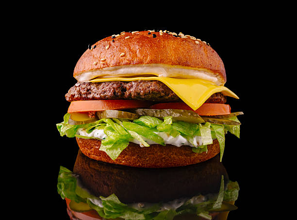 istock Delicious cheeseburger with fresh ingredients on a black background 2225054385