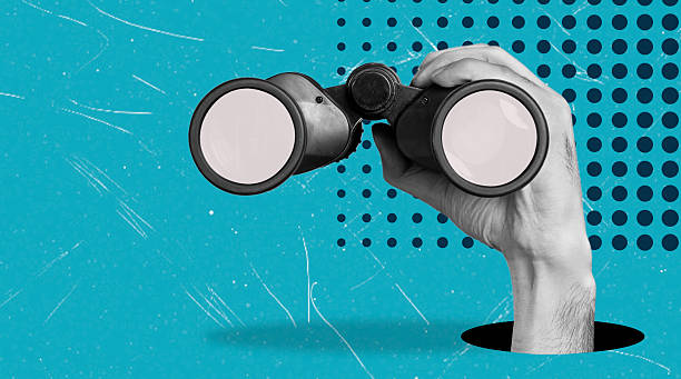 istock Art collage, Hand holding binoculars on a bright blue background with dotted patterns, emphasizing focus and observation 2225054388