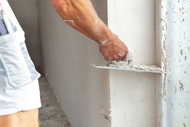 istock Plasterer smoothing and levelling interior walls 2225057827