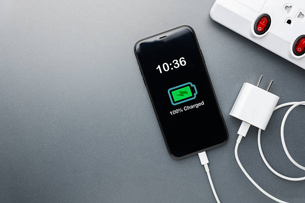 istock Smartphone Fully Charged with USB Adapter Unplugged for Power Management 2225059380