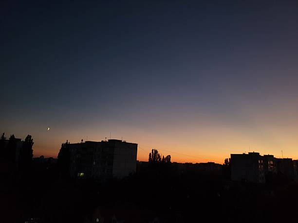 istock City silhouette at sunset with orange sky 2225059895