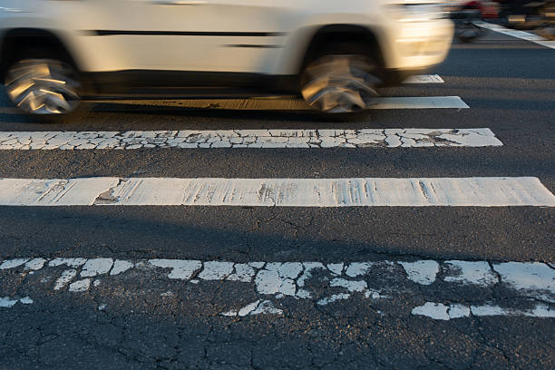 istock Blurred car speeding through a pedestrian crossing. Traffic sign. 2225061518