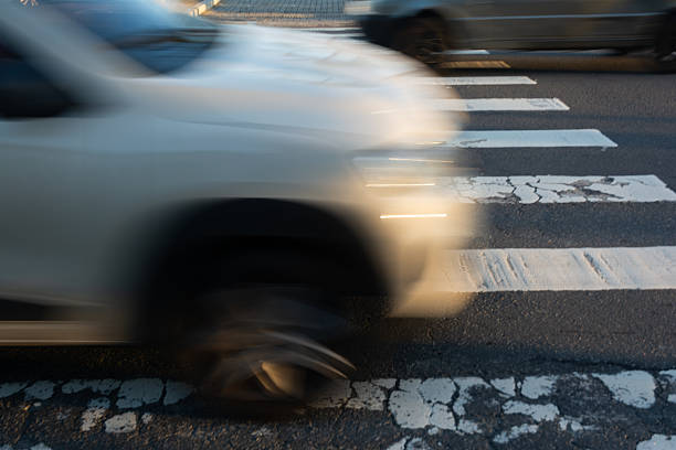 istock Blurred car speeding through a pedestrian crossing. Traffic sign. 2225061519