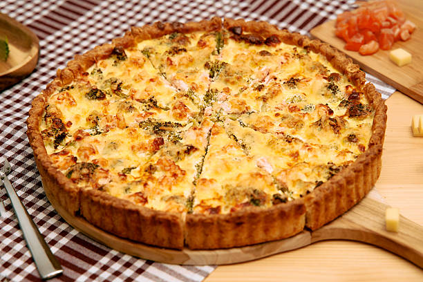 istock Delicious homemade quiche with broccoli and cheese on checkered tablecloth 2225061885