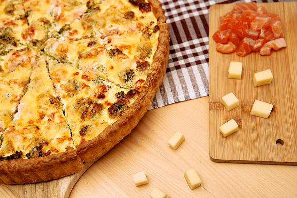 istock Savory quiche and cheese with salmon on wooden board 2225062190