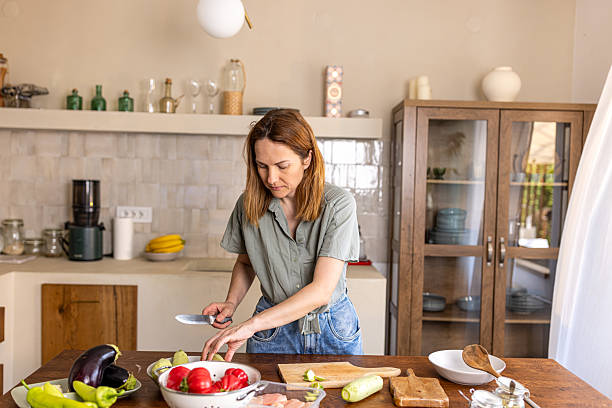 istock Woman creating a healthy dish in her home kitchen 2225062285