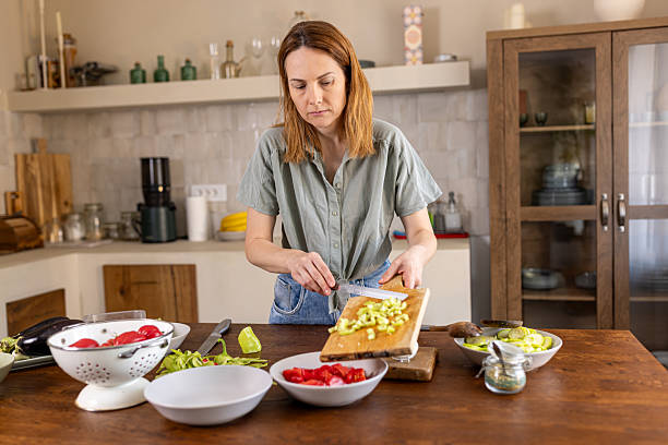 istock Woman creating a healthy dish in her home kitchen 2225062323