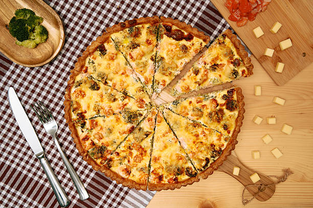 istock Homemade vegetable quiche with broccoli and cheese on wooden table setting 2225062507