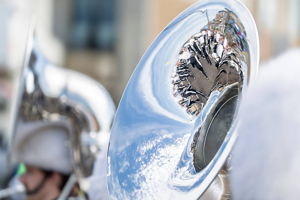 A monochrome close-up of a vintage brass bugle against a dark background. The black and white tones highlight the instrument’s textures and metallic reflections, evoking a sense of history, ceremony, and tradition. A timeless capture of a classic military and musical symbol.