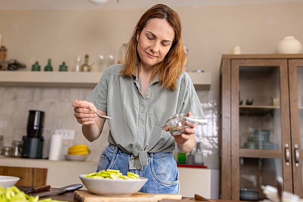 istock Woman creating a healthy dish in her home kitchen 2225062735