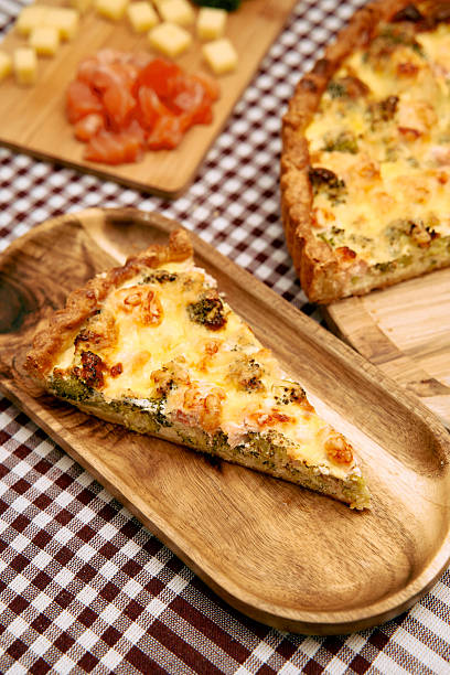 istock Savory quiche slice with broccoli and cheese on wooden plate checkered tablecloth 2225062854