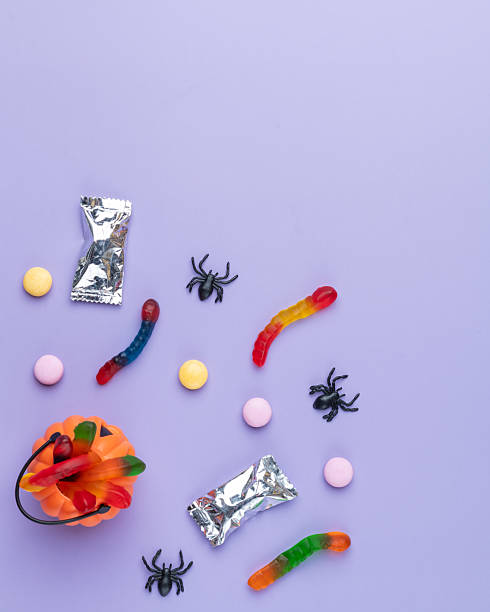 istock Assorted colorful candies over purple background with copy space 2225063057