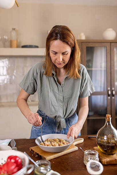 istock Woman putting some spices in a meal 2225063128