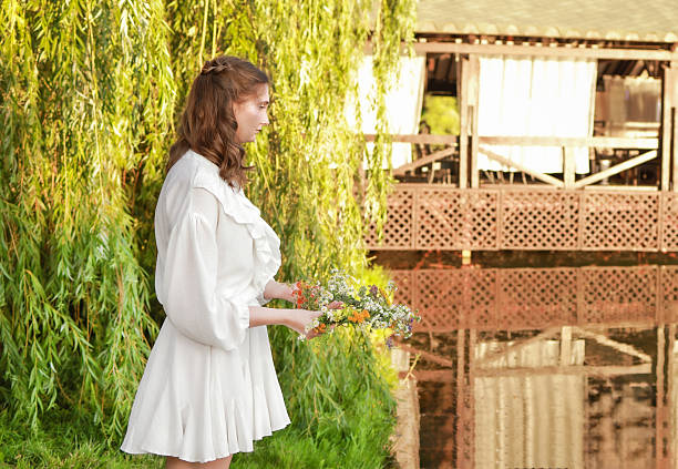 On Ivan Kupala, a girl makes a wish and throws a wreath into the river.