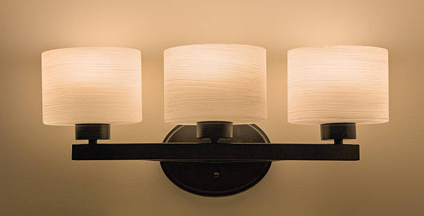 istock Three‑Light Black Vanity Fixture Casting Soft Glow 2225063562