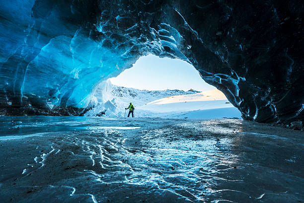 istock Hiker exploring ice cave in the alps, Italy 2225064474