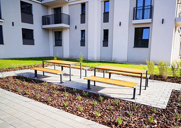 istock Courtyard area in condominium complex. Street table and bench, chairs 2225065379