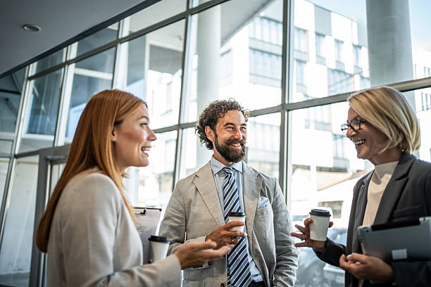 istock Business people talking during coffee break in office hallway 2225066881
