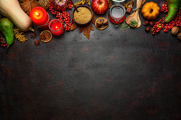 istock Autumn or Thanksgiving border. Decor with burning candles, fallen leaves, nuts, cinnamon sticks and pumpkin. Greeting card or copy space. October or season. Happy Thanksgiving 2225067396