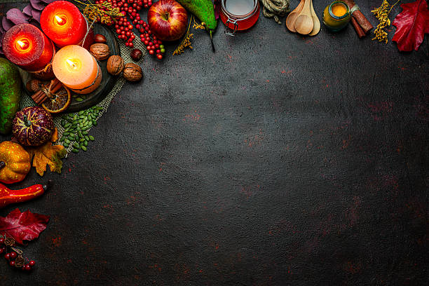 istock Autumn or Thanksgiving border. Decor with burning candles, fallen leaves, nuts, cinnamon sticks and pumpkin. Greeting card or copy space. October or season. Happy Thanksgiving concept 2225067401
