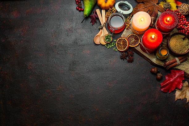 istock Autumn or Thanksgiving border. Decor with burning candles, fallen leaves, nuts, cinnamon sticks and pumpkin. Greeting card or copy space. October or season. Happy Thanksgiving 2225067406
