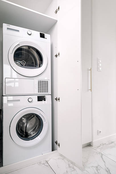 istock Modern washing machine and dryer pair in a stylish laundry space 2225069147