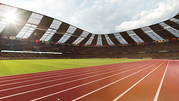 istock Outdoor 3D stadium track with green field and sunlight over cheering crowd 2225070065