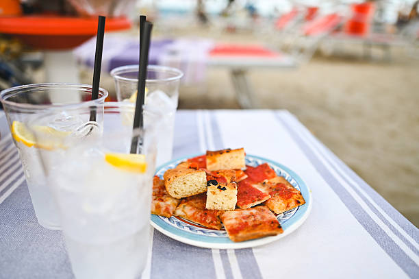 istock Enjoying pizza and lemonade by the beach on a sunny day 2225071089