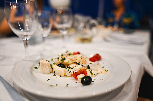 istock Delicious swordfish carpaccio with tomatoes and olives served on a restaurant table 2225072706