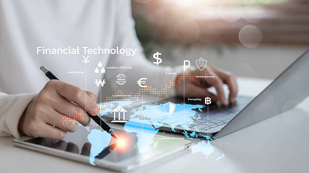 istock Hand using tablet and laptop with global financial technology interface, showing fintech services like e-wallet, cryptocurrency, mobile banking, and online payment systems. 2225072902