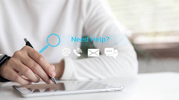 istock Close-up hand using a stylus on a tablet with digital contact icons and Need Help ? message. Concept of customer support, help desk, and online service assistance. 2225072916